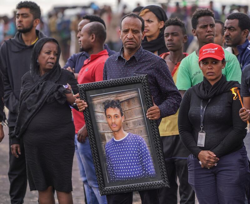 The father of 28-year-old Captain Yared Getecho holds his son's photograph. Getty Images