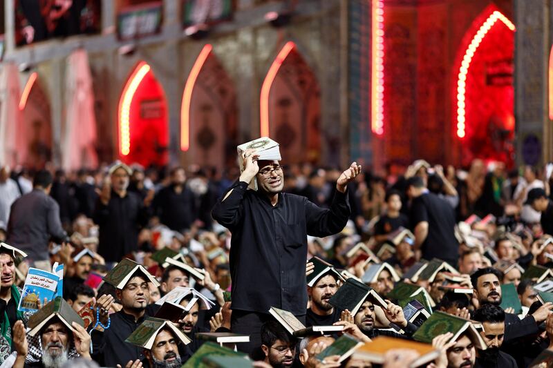 Worshippers with the Quran on their heads