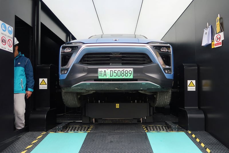 A Nio ES8 electric SUV has its battery changed inside a power station at a JAC Motors plant in Hefei, China. Reuters