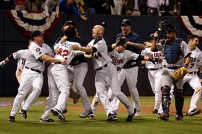 The Minnesota Twins celebrate after defeating the Detroit Tigers by one run in a dramatic sudden-death play-off to decide the team to go through to the post-season.