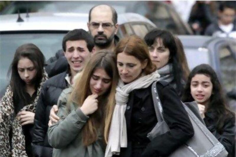 Relatives mourn outside the school in Toulouse, southern France, after a gunman killed three students and a teacher.
