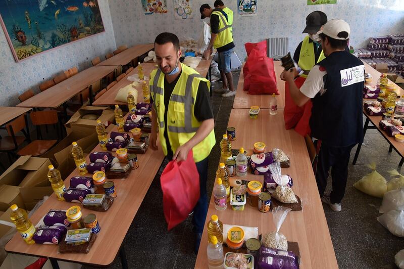 Algerian volunteers, part of the charitable association "Joy of Eid", fill food parcels to be distributed to needy families ahead of the Muslim Eid Al Fitr in the capital Algiers.    AFP