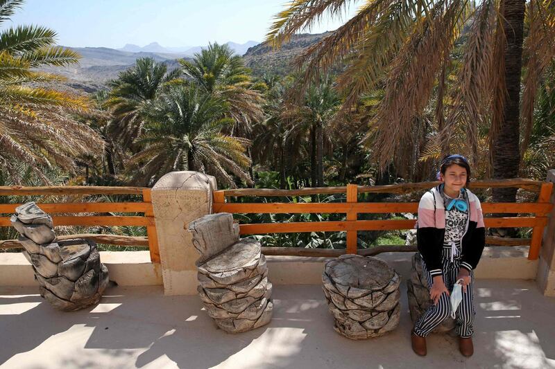 A girl sits outside a boutique hotel in Misfat Al Abriyeen, a popular tourist spot in a region renowned for hiking trails and tales of genies. AFP