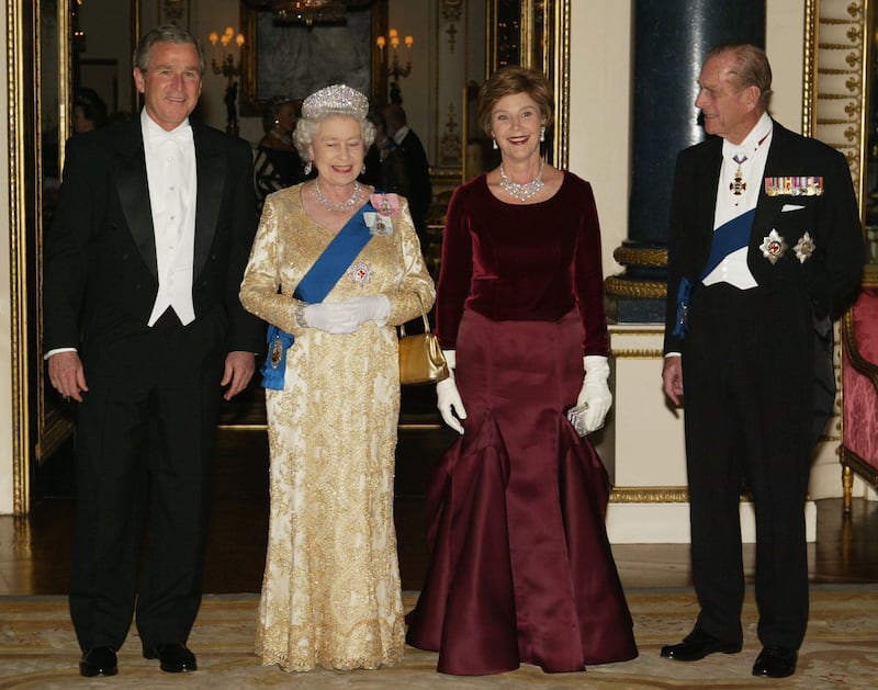 Former US president George W. Bush, Queen Elizabeth, Laura Bush and Prince Philip pose in the music room at Buckingham Palace in November 2003. Getty Images