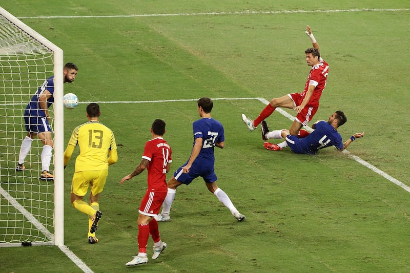Bayern Munich's Thomas Muller shoots and scores. Suhaimi Abdullah / Getty Images