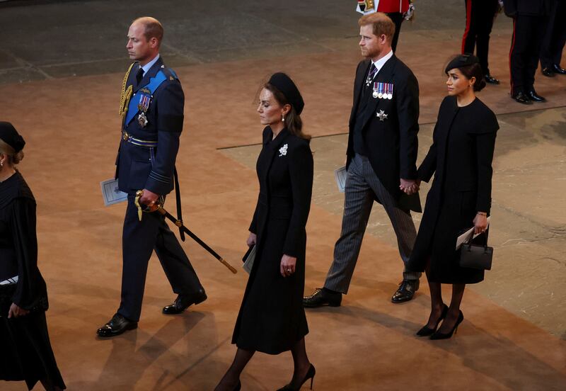 Prince William, Catherine, Princess of Wales, Prince Harry and Meghan, Duchess of Sussex, walk in the procession as it arrives at Westminster Hall. AP
