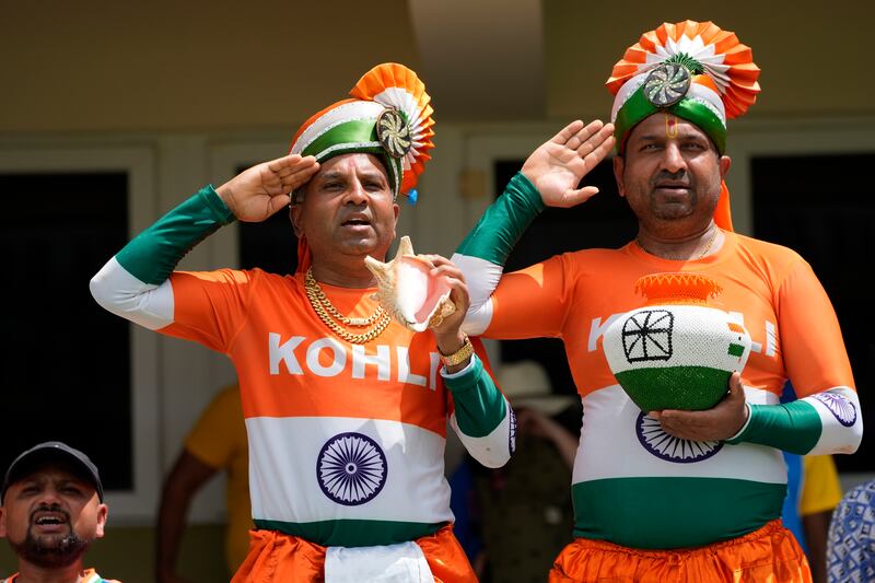 Indian supporters salute their team from the stands. AP