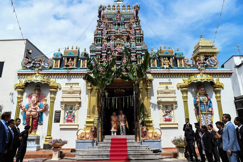 Britain's Prince Charles, Prince of Wales and Camilla, Duchess of Cornwall pose for pictures at the main entrance of the Sri Mahamariamman Temple in George Town, Penang, Malaysia.  Mohd Rafsan / AFP Photo