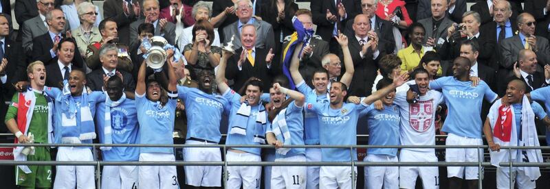 LONDON, ENGLAND - MAY 14:  Carlos Tevez lifts the trophy after he and his Manchester City team mates won the FA Cup sponsored by E.ON Final match between Manchester City and Stoke City at Wembley Stadium on May 14, 2011 in London, England.  (Photo by Shaun Botterill/Getty Images)