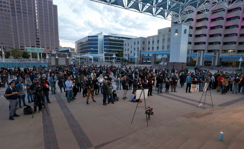 A large crowd of movie industry workers and New Mexico residents attend the candlelight vigil. AP