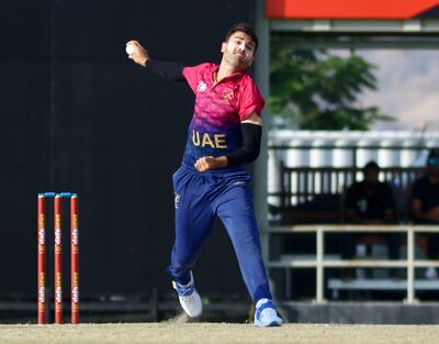 Omid Rahman bowls for the UAE in the final of ACC Men's Premier Cup against Oman. Subas Humagain for The National