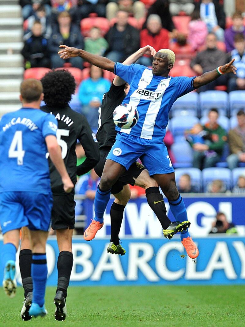 Wigan Athletic's Arouna Kone, right, and Everton's Leighton Baines, rear, battle for the ball during the English Premier League soccer match at the DW Stadium, Wigan, England, Saturday Oct. 6, 2012. The match ended in a 2-2 draw. (AP Photo/PA, Martin Rickett) UNITED KINGDOM OUT  NO SALES  NO ARCHIVE *** Local Caption ***  Britain Soccer Premier League.JPEG-06d08.jpg