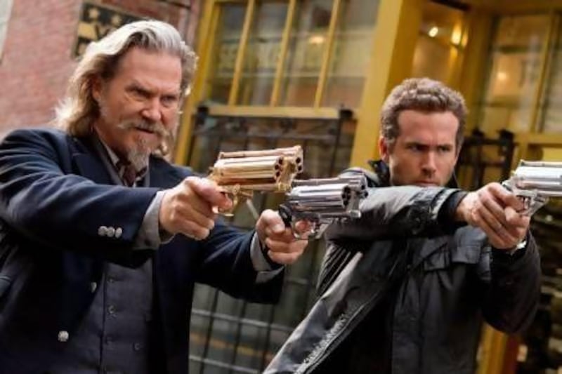 Jeff Bridges, left, and Ryan Reynolds in a scene from R.I.P.D. Courtesy Universal Pictures / AP Photo