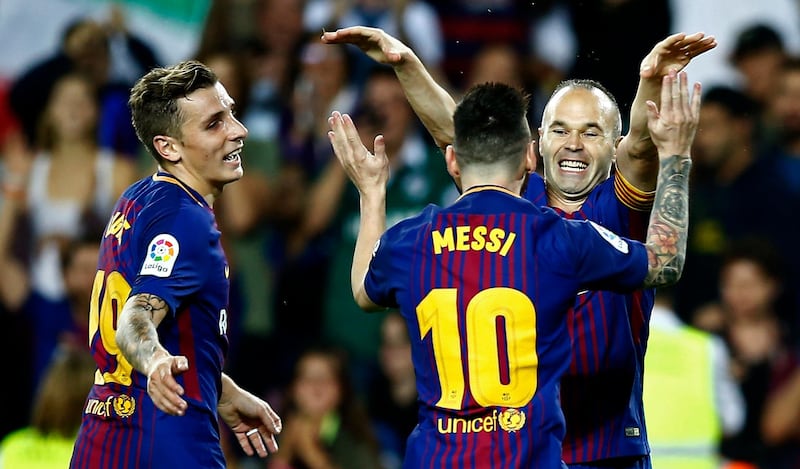 FC Barcelona's Andres Iniesta, right, celebrates after scoring during the Spanish La Liga soccer match between FC Barcelona and Malaga at the Camp Nou stadium in Barcelona, Spain, Saturday, Oct. 21, 2017. (AP Photo/Manu Fernandez)