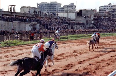 Jockeys compete during a horse race at Beirut Hippodrome, Lebanon, in 1992. REUTERS/Jamal Saidi  