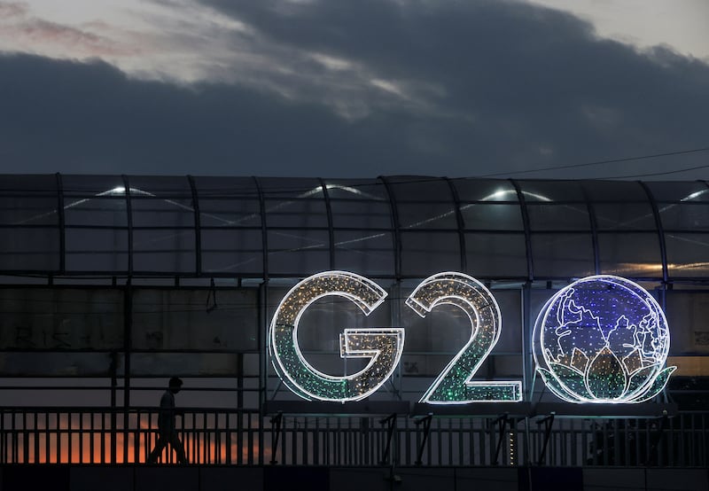 A man walks past an installation on a skywalk ahead of the G20 summit in New Delhi, India. Reuters