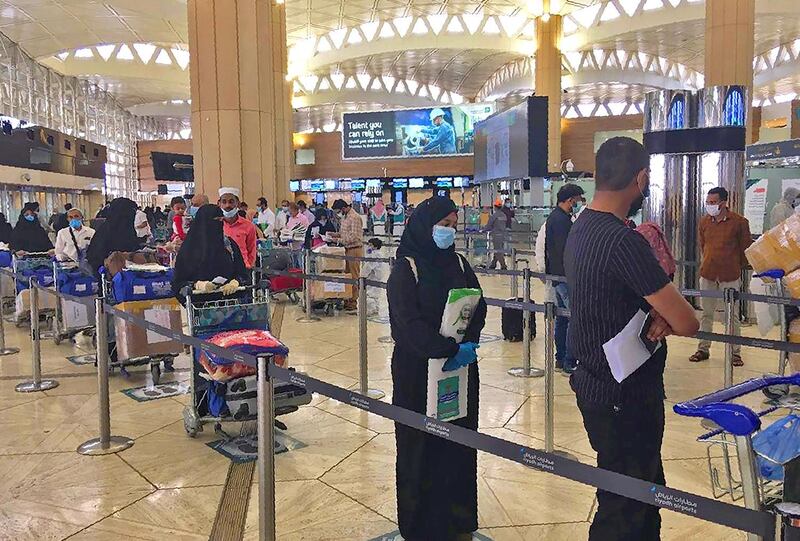 A picture provided by the embassy of India in Riyadh shows Indian expats queuing at departure section in King Fahad International Airport heading to Kozhikode. AFP / Embassy of India in Riyadh