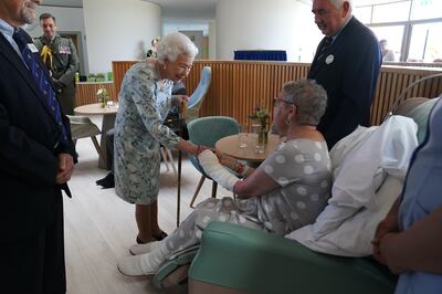 Queen Elizabeth II meeting patient Pat White during a visit to officially open the new building at Thames Hospice, Maidenhead, in what became her final public engagement in July. PA
