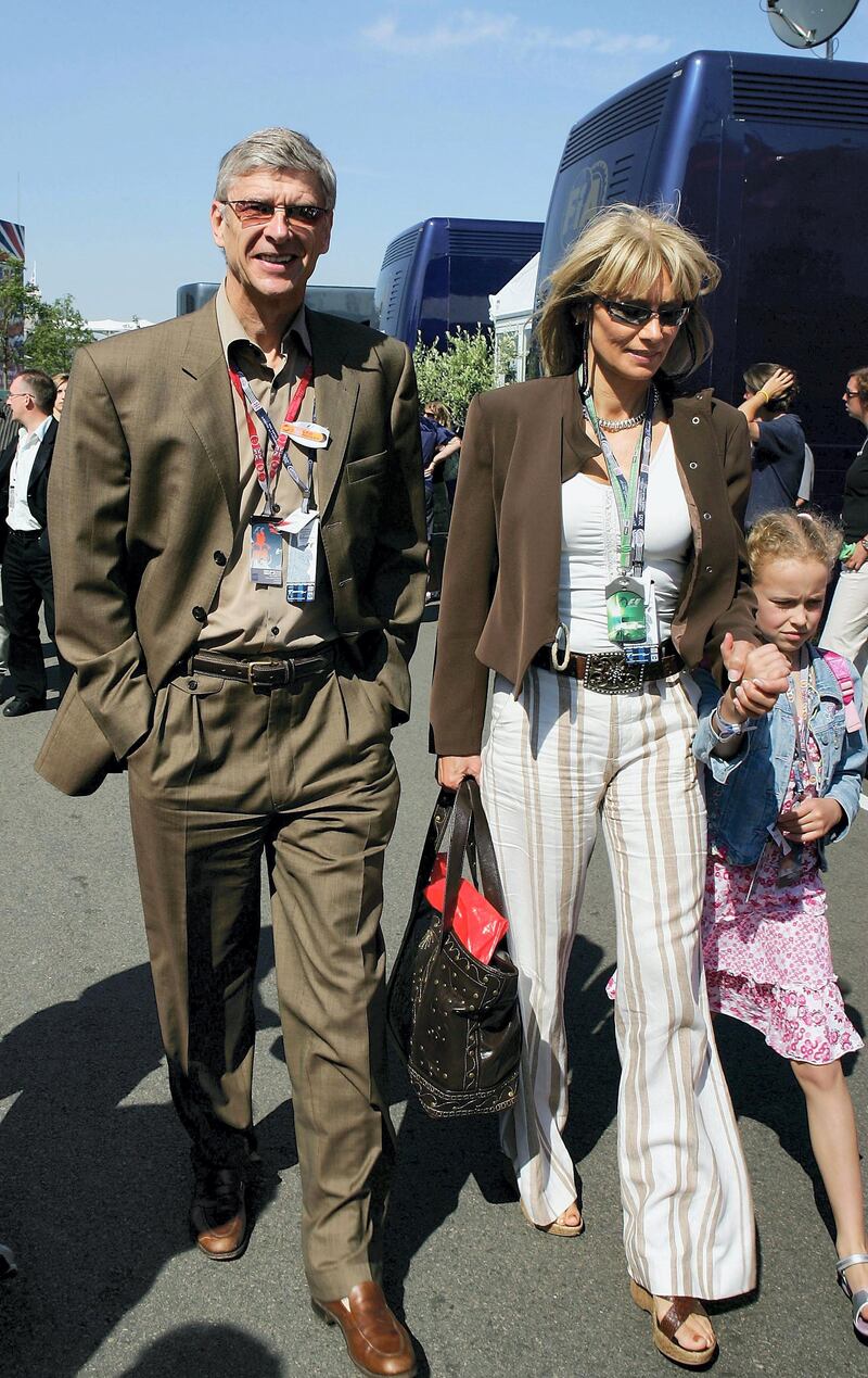 SILVERSTONE, ENGLAND - JULY 10:  Manager Arsene Wenger of Arsenal walks down the paddock with his family during the British F1 Grand Prix at Silverstone Circuit on July 10, 2005 in Silverstone, England. (Photo by Mark Thompson/Getty Images)