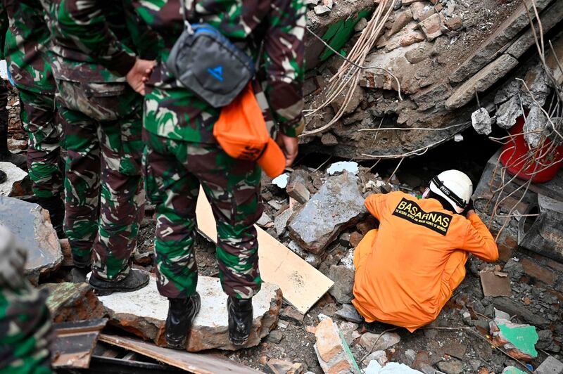 Rescuers search for survivors at a collapsed building in Mamuju city on January 16, 2021, a day after a 6.2-magnitude earthquake rocked Indonesia's Sulawesi island. AFP