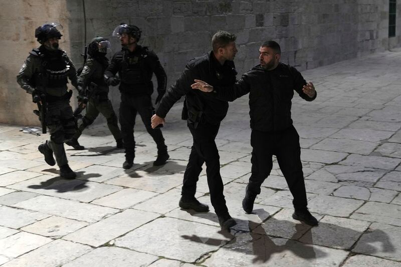 A Palestinian worshipper is led away by Israeli police at Al Aqsa Mosque compound. AP