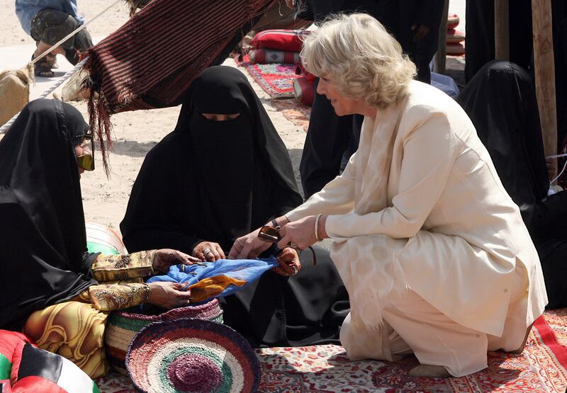 The Duchess of Cornwall talks to Emirati women in Dubai's historical district of Bastakiah in February 2007. AFP