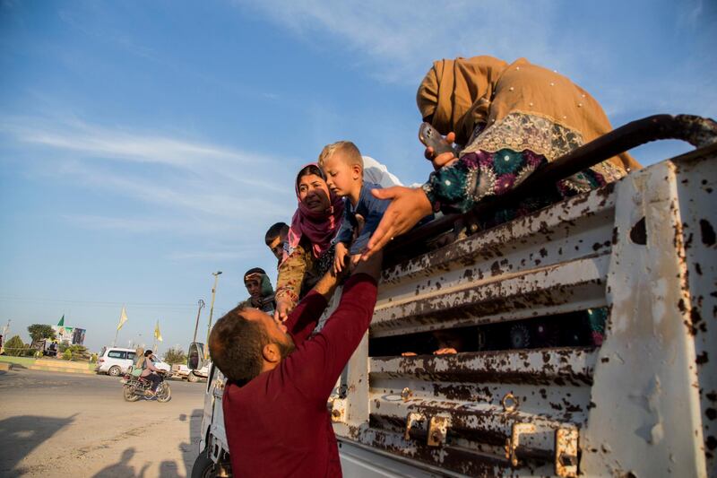 Syrians fleeing Turkish advance arrive to the town of Tal Tamr in north Syria. Syrian government troops moved into towns and villages in northern Syria on Monday, setting up a potential clash with Turkish-led forces advancing in the area as long-standing alliances in the region begin to shift or crumble following the pullback of U.S. forces. AP Photo