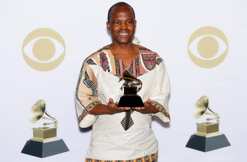 Joseph Shabalala of the group Ladysmith Black Mambazo holds the Grammy for Best World Music Album in the press room during the 60th annual Grammy Awards. EPA