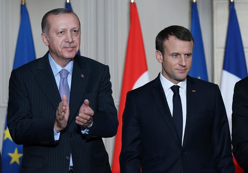 French President Emmanuel Macron, right, and Turkish President Recep Tayyip Erdogan stand during a signing ceremony at the Elysee Palace in Paris, Friday, Jan. 5, 2018.  Erdogan is in Paris for talks with Macron amid protests over press freedom and the deteriorating state of human rights in Turkey. (Yasin Bulbul/Pool Photo via AP)