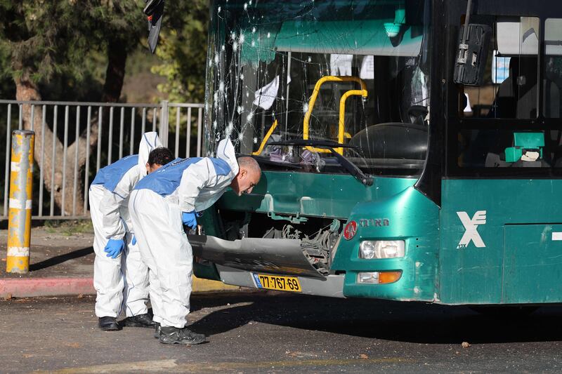 Israeli forensic experts at work at the scene of an explosion at a bus stop in Jerusalem on November 23.  One person was killed and at least 15 were injured in two separate explosions, security and medical officials said. AFP