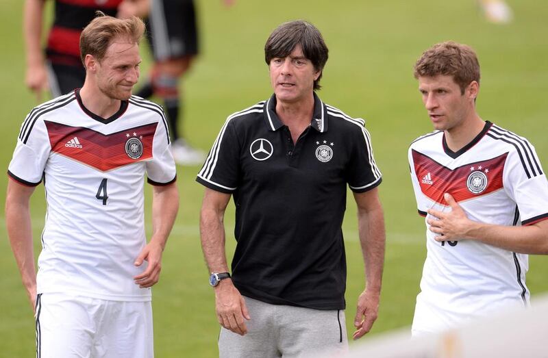 Germany manager Joachim Low, centre, talks to players Benedikt Howedes, left, and Thomas Muller during the training match against the German U-20 team on Sunday. Andreas Gebert / EPA