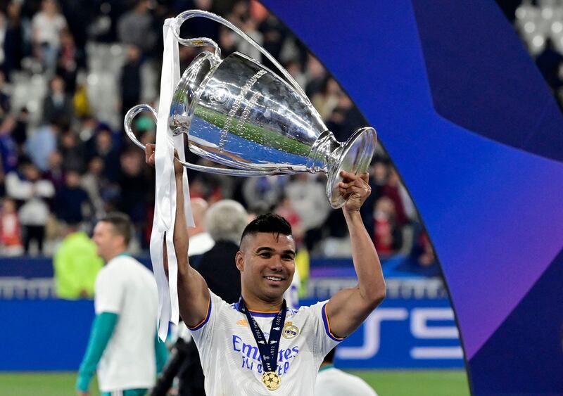 Real Madrid's Casemiro celebrates with the trophy after his side's Uefa Champions League final victory against Liverpool at the Stade de France on May 28, 2022. AFP