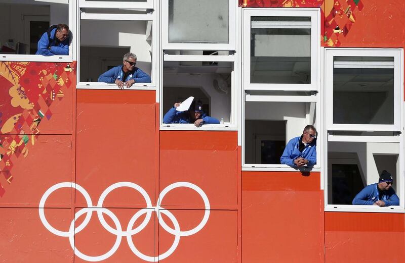 Judges watch an attempt during the men's normal hill ski jumping training on Friday. Matthias Schrader / AP 
