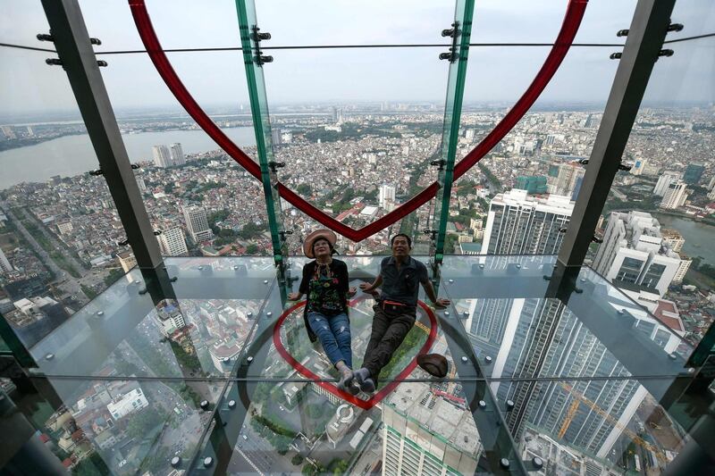 A couple pose for photos on the Skywalk Observation Deck at Lotte Centre in Hanoi. AFP