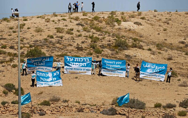 Activists from the Palestinian initiative Women of the Sun and Israeli movement Women Wage Peace demonstrate opposite the Kedma Hotel. AFP