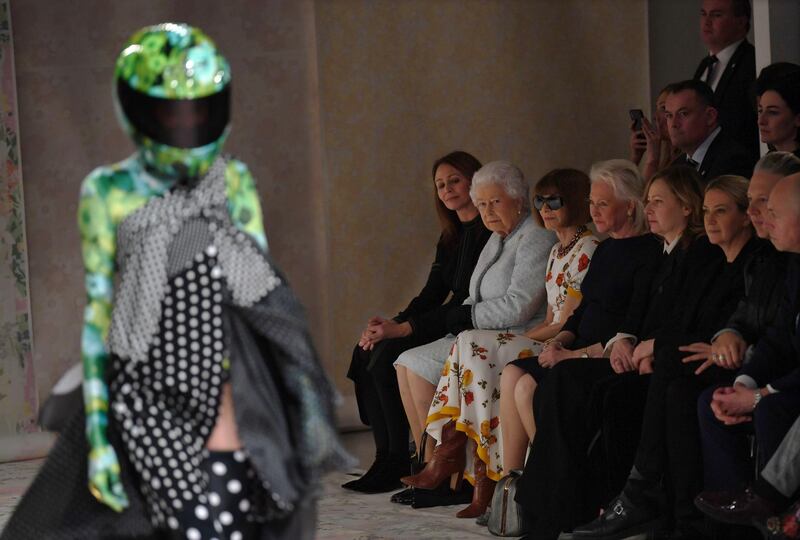 Queen Elizabeth sat front row at the 28-year-old designer's show - he's known for employing unusual headgear on the red carpet. We wonder if we'll see floral helmets at the upcoming royal wedding? Neil Hall / EPA