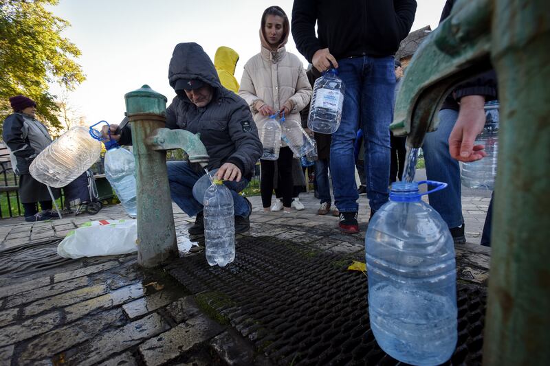 People take water from a water pump in Kyiv. EPA