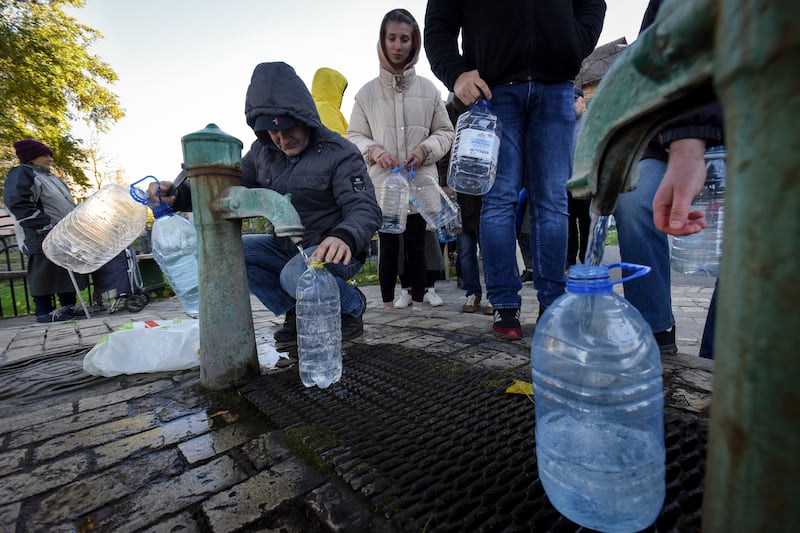 People take water from a water pump in Kyiv. EPA
