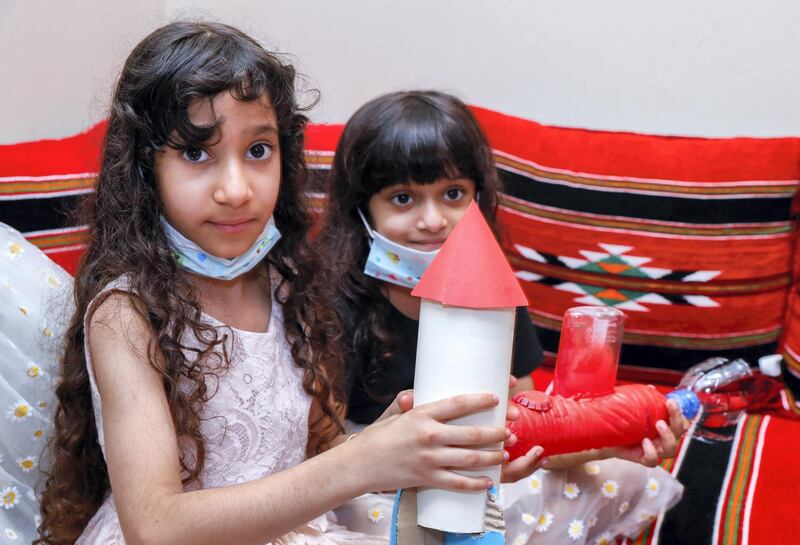 Abu Dhabi, United Arab Emirates, August 11, 2020.   ADNOC Family Education.  Alzaabi kids with their art projects::  (L-R) Hend-8 and Meera-6 show their artworks.
Victor Besa /The National
Section: NA
Reporter:  Mustafa Alrawi