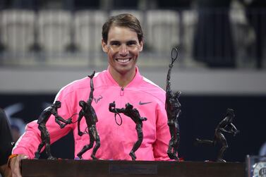 Rafael Nadal holds his trophy after winning an exhibition game against compatriot David Ferrer to inaugurate the Rafa Nadal Academy Kuwait. AFP