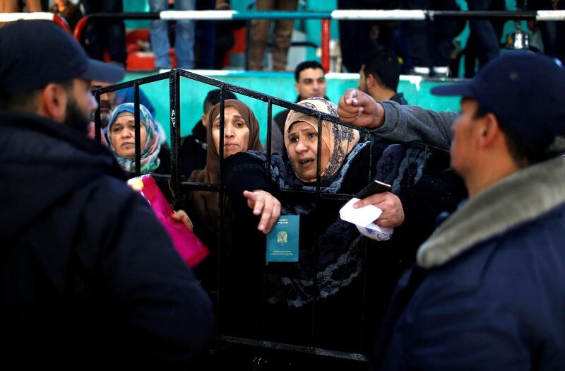 People wait for travel permits to cross into Egypt through the Rafah border crossing after it was opened by Egyptian authorities for humanitarian cases, in the southern Gaza Strip February 21, 2018. REUTERS/Mohammed Salem