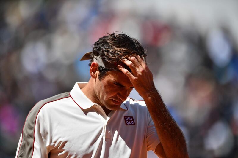 Federer reacts as he plays against Nadal. AFP