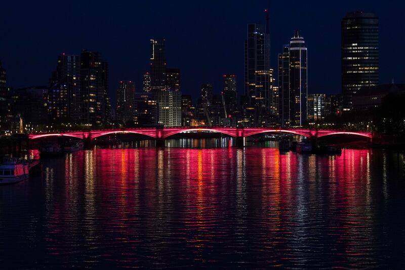 Lambeth Bridge is lit red for the occasion. Getty