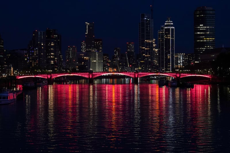 Lambeth Bridge is lit red for the occasion. Getty