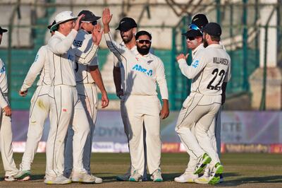 New Zealand's Ajaz Patel, centre, celebrates with teammates after taking the wicket of Pakistan's Agha Salman. AP)