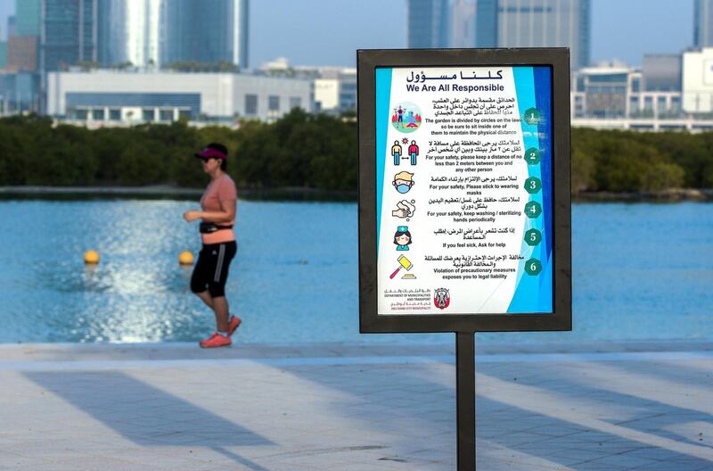 Abu Dhabi, United Arab Emirates, July 10, 2020.   
 A Covid-19 sign along Reem Beach reminds residents exercising to be responsible.
Victor Besa  / The National
Section:  Standalone
Reporter: