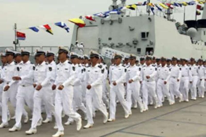 Chinese Navy sailors march past a warship at port before leaving for the Navy's first oversea operation from Sanya, southern China's Hainan province.