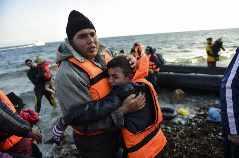 Refugees arrive on the Greek island of Lesbos on November 17, 2015, after crossing the Aegean Sea from Turkey. Bulent Kilic/AFP Photo

