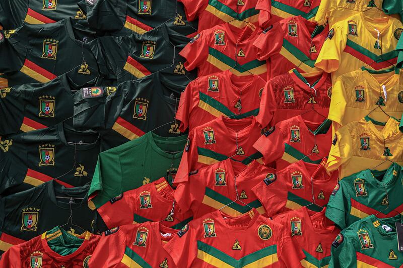 Cameroonian football jerseys hang along a wall at the central market in Yaounde. AFP