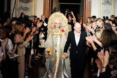 A model walks with the designer on the runway at the Christian Lacroix fashion show during Paris Fashion Week Haute Couture Autumn/Winter 2009/2010 on July 7, 2009 in Paris, France. Getty Images 